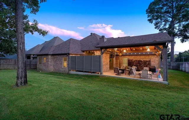 a view of a house with backyard porch and sitting area