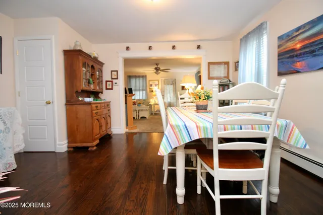 a view of a dining room with furniture and a chandelier