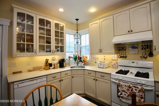 a kitchen with stainless steel appliances a refrigerator sink and cabinets