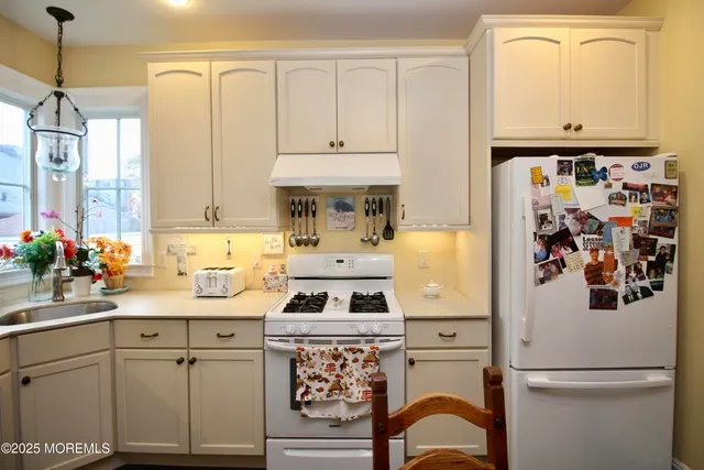 a kitchen with a sink and a stove top oven