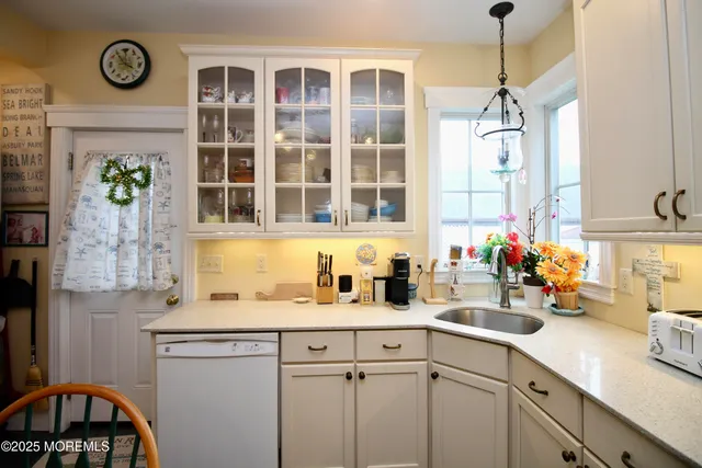 a kitchen counter with sink and window