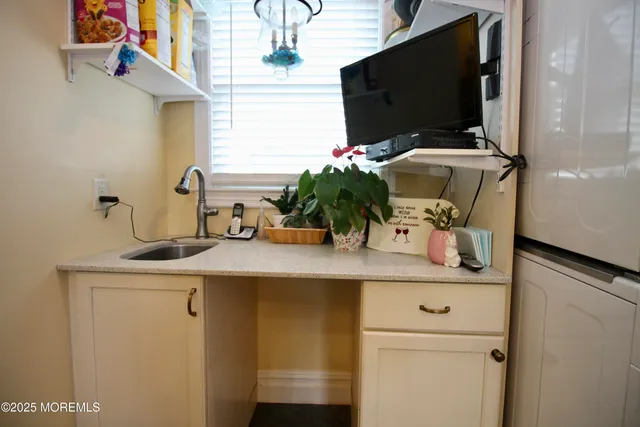 a utility room with sink dryer and washer