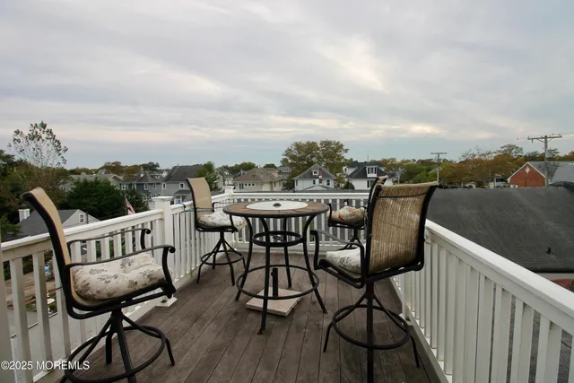 a balcony with table and chairs