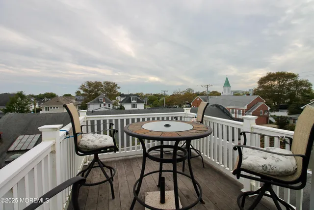 a balcony with table and chairs