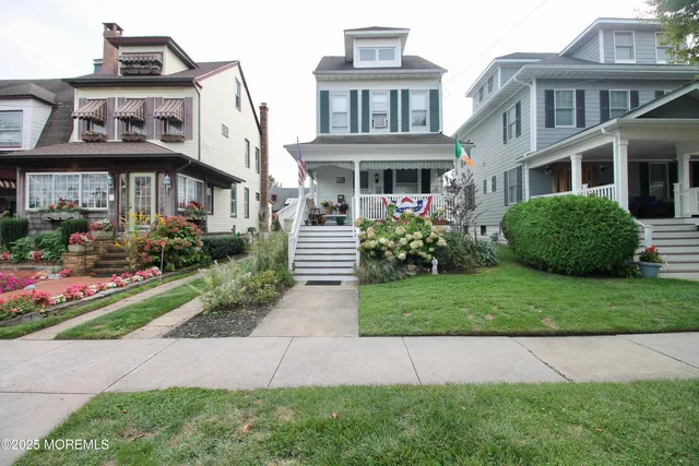 a front view of a house with a yard and outdoor seating