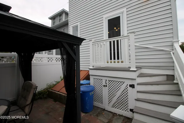 a view of roof deck with dining table and chairs
