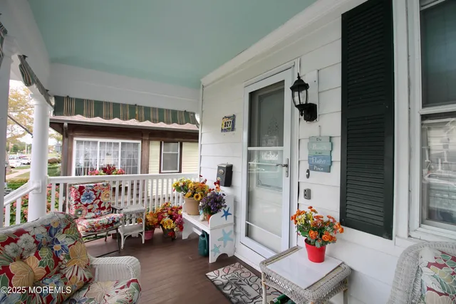 a front view of a house with outdoor seating