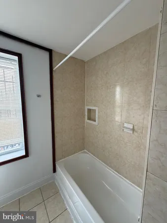 a bathroom with a tub and shower