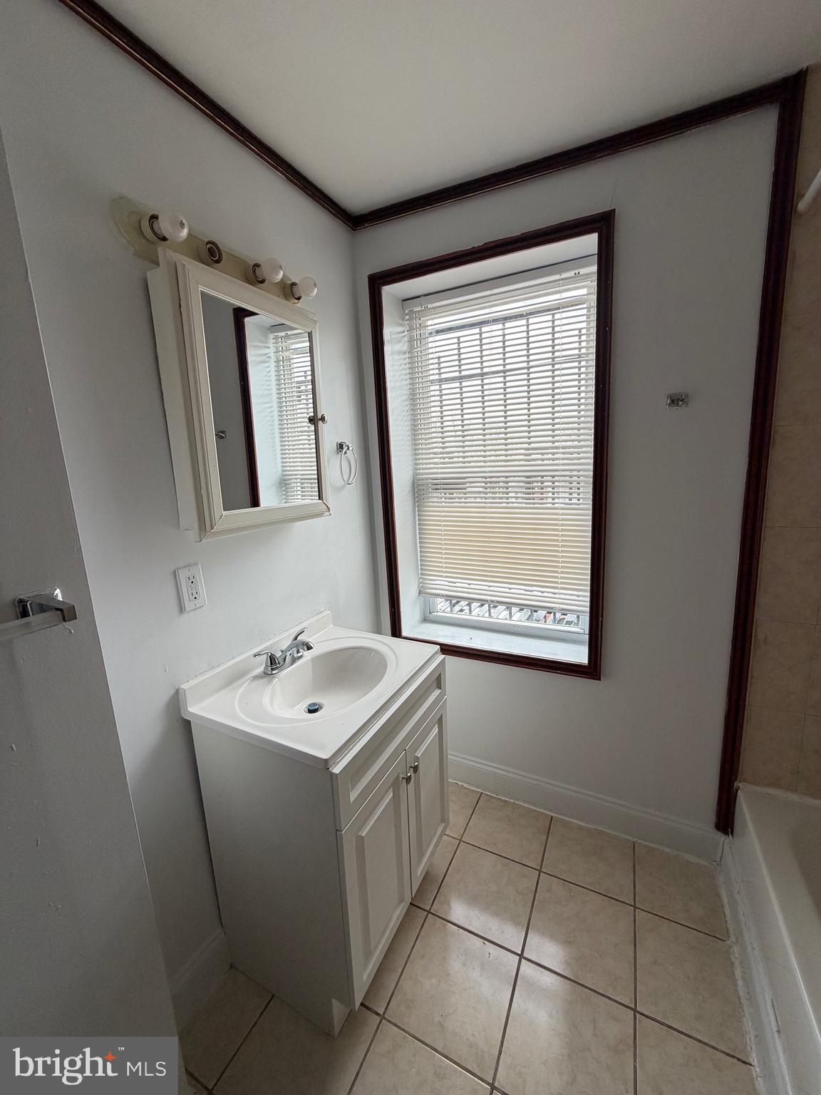 1841 West Lexington Street, Unit 3 Baltimore, MD 21223 - Photo 9 of 14 a bathroom with a sink a toilet and mirror