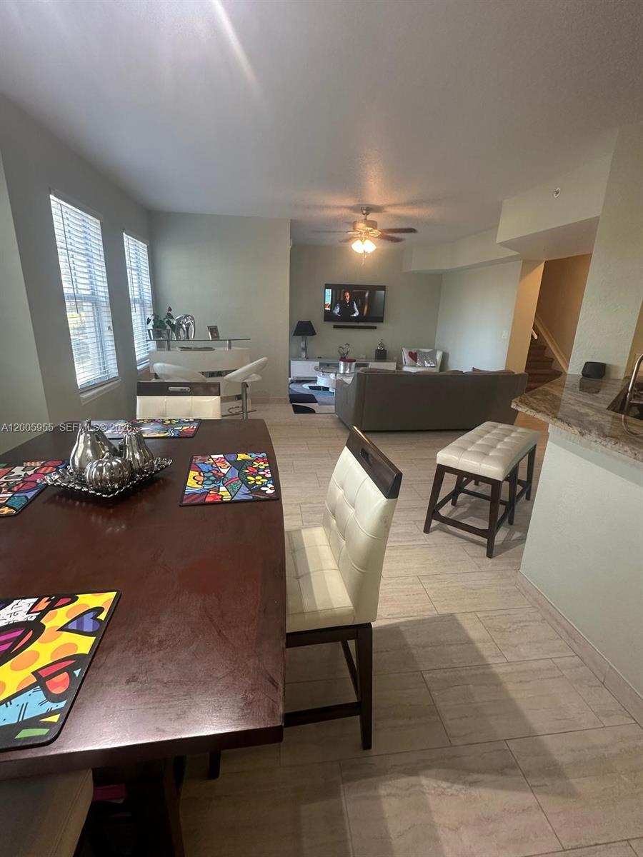 6920 West Sample Road, Unit 6920 Pompano Beach, FL 33063 - Photo 15 of 30 a living room with furniture and a table