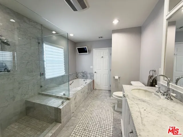 a bathroom with a tub sink and toilet