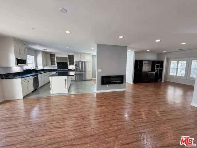 a view of kitchen with cabinets and wooden floor