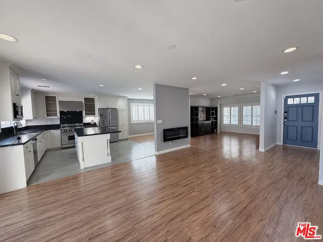 a view of kitchen with cabinets and wooden floor