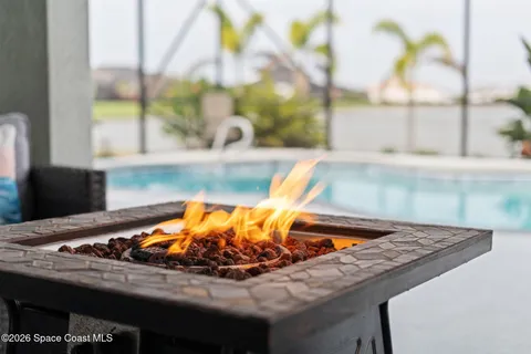a dining room with furniture a rug and a chandelier