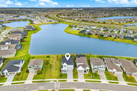 a large kitchen with kitchen island granite countertop lots of white cabinets appliances and furniture