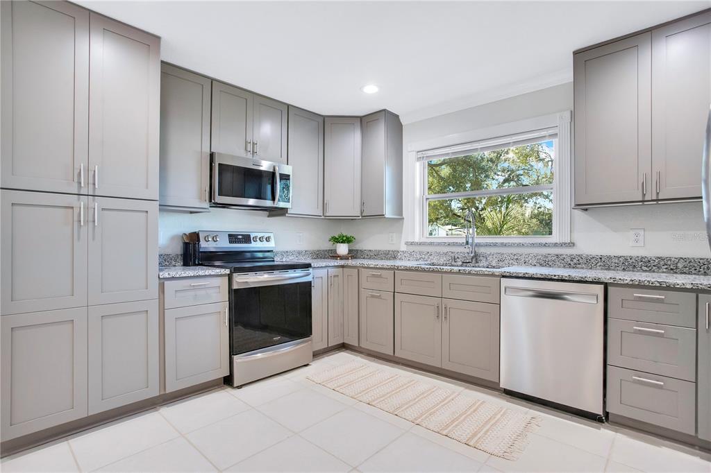 619 Marphil Loop Brandon, FL 33511 - Photo 13 of 36 a kitchen with granite countertop stainless steel appliances white cabinets granite counter tops and a window