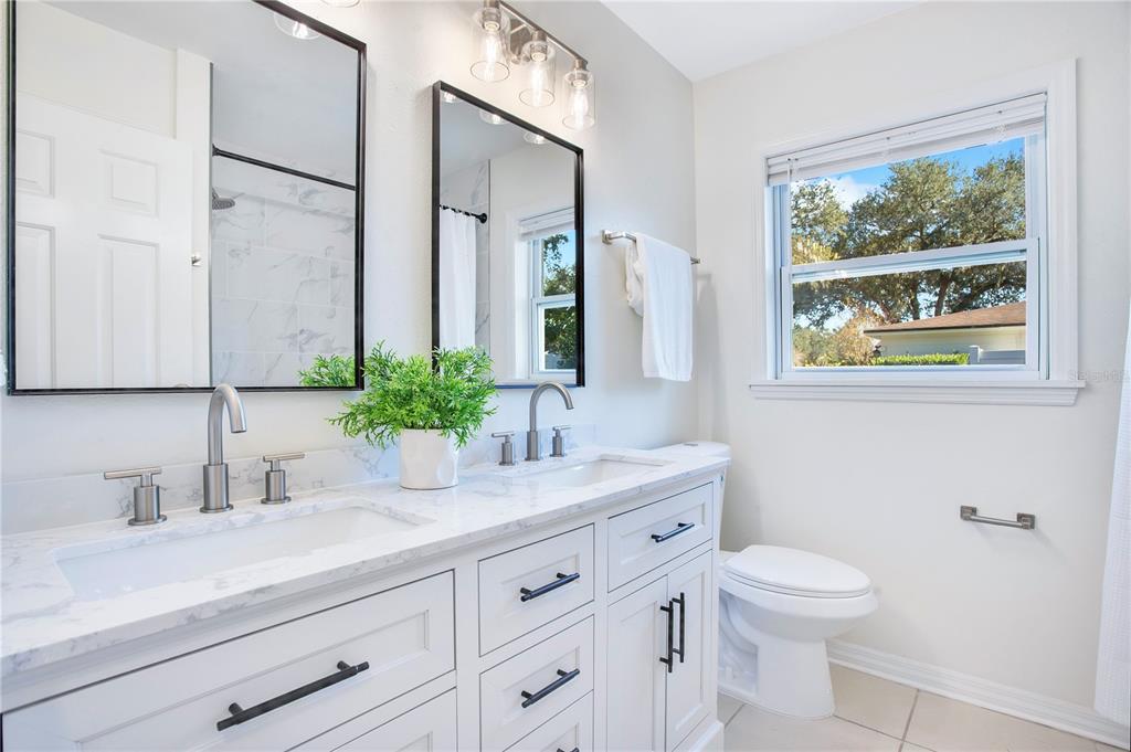 619 Marphil Loop Brandon, FL 33511 - Photo 23 of 36 a bathroom with a granite countertop sink mirror vanity and toilet