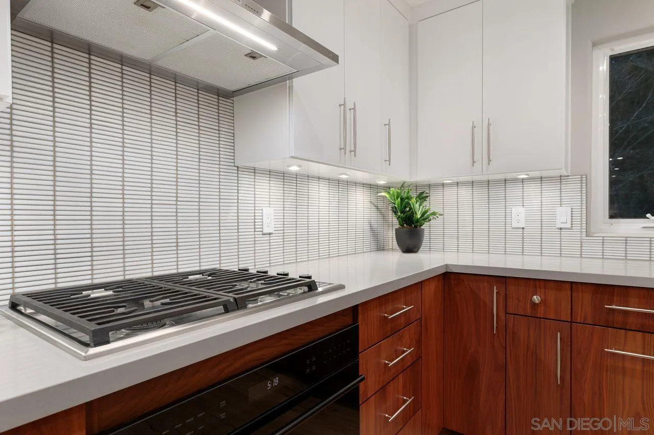 751 Hoska Drive Del Mar, CA 92014 - Photo 18 of 43 a kitchen with a sink stove and cabinets