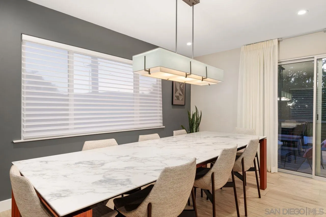 751 Hoska Drive Del Mar, CA 92014 - Photo 20 of 43 a dining room with a table chairs and white kitchen view