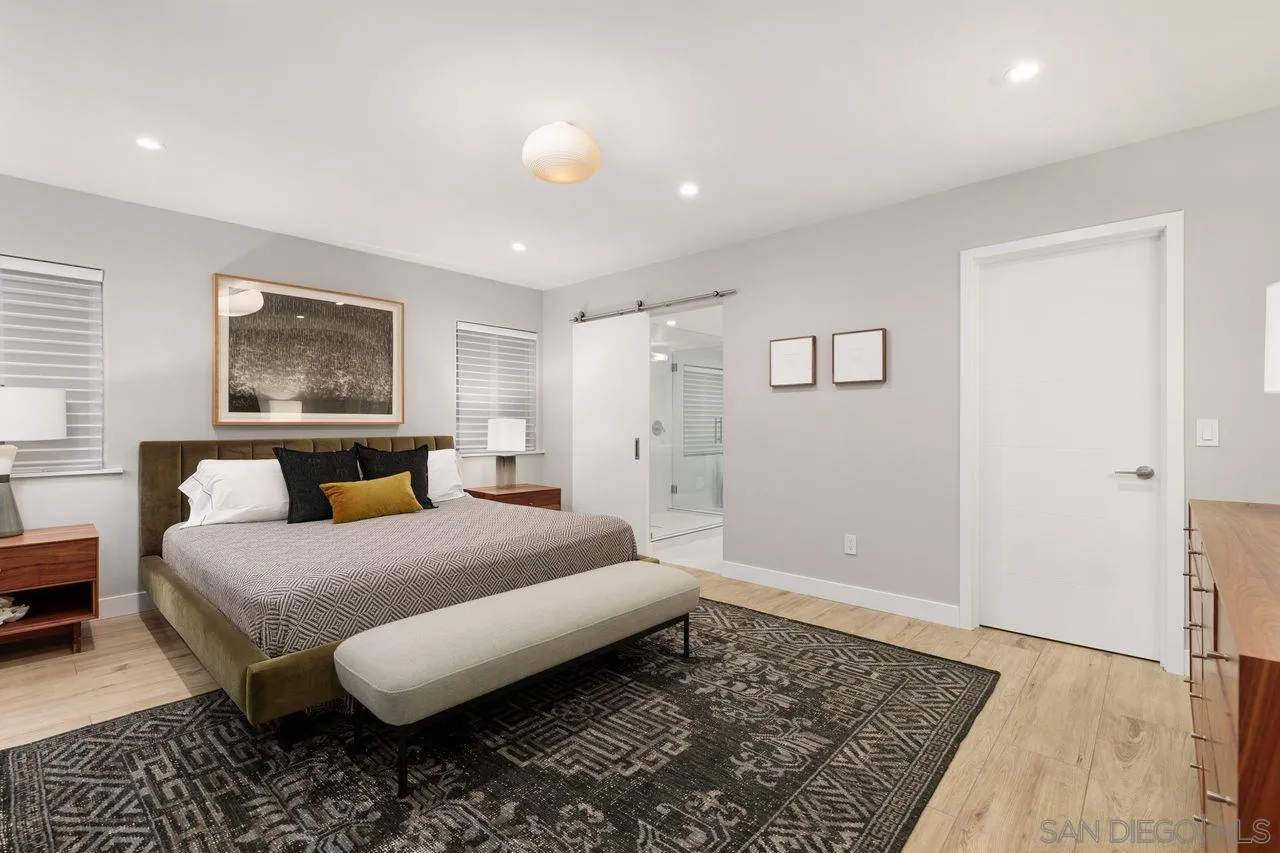 751 Hoska Drive Del Mar, CA 92014 - Photo 32 of 43 a spacious bedroom with a bed and a rug