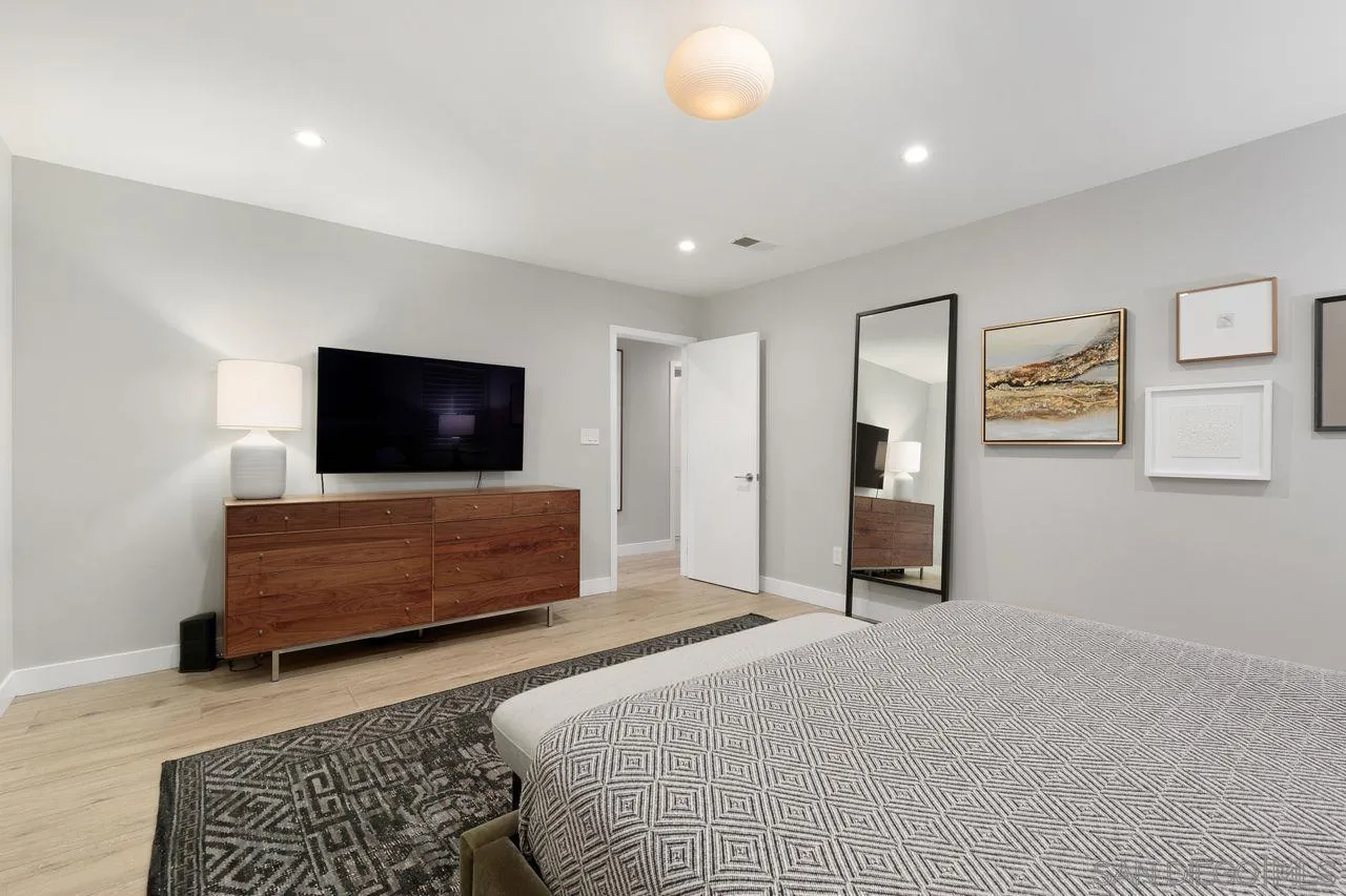 751 Hoska Drive Del Mar, CA 92014 - Photo 33 of 43 a bedroom with furniture and flat screen tv