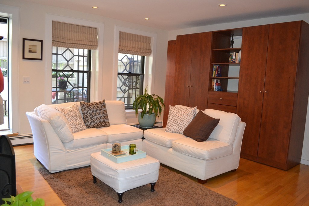 315-317 Beacon Street, Unit 1 Boston, MA 02116 - Photo 4 of 11 a living room with furniture and large window