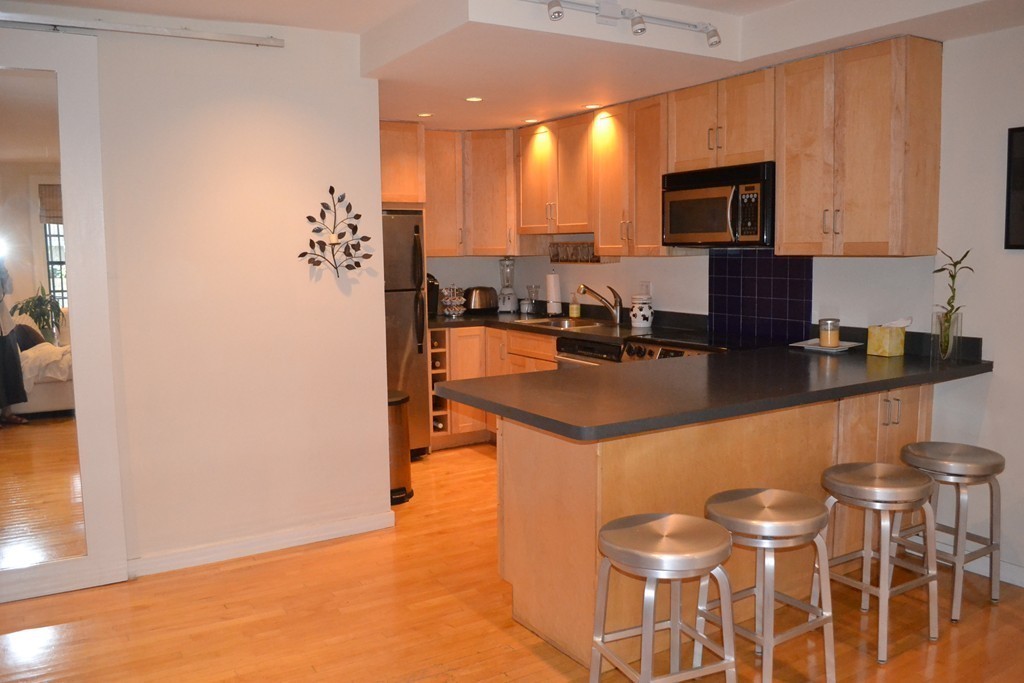 315-317 Beacon Street, Unit 1 Boston, MA 02116 - Photo 5 of 11 a kitchen with a sink and cabinets