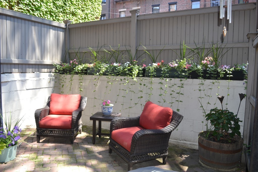 315-317 Beacon Street, Unit 1 Boston, MA 02116 - Photo 8 of 11 a view of a chair and table in backyard