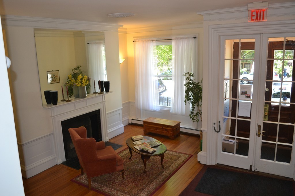 315-317 Beacon Street, Unit 1 Boston, MA 02116 - Photo 10 of 11 a living room with furniture and a fireplace