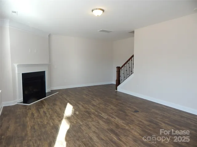 a view of an empty room and wooden floor
