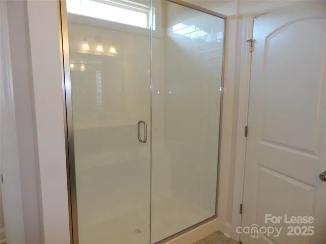 a bathroom with a glass shower door