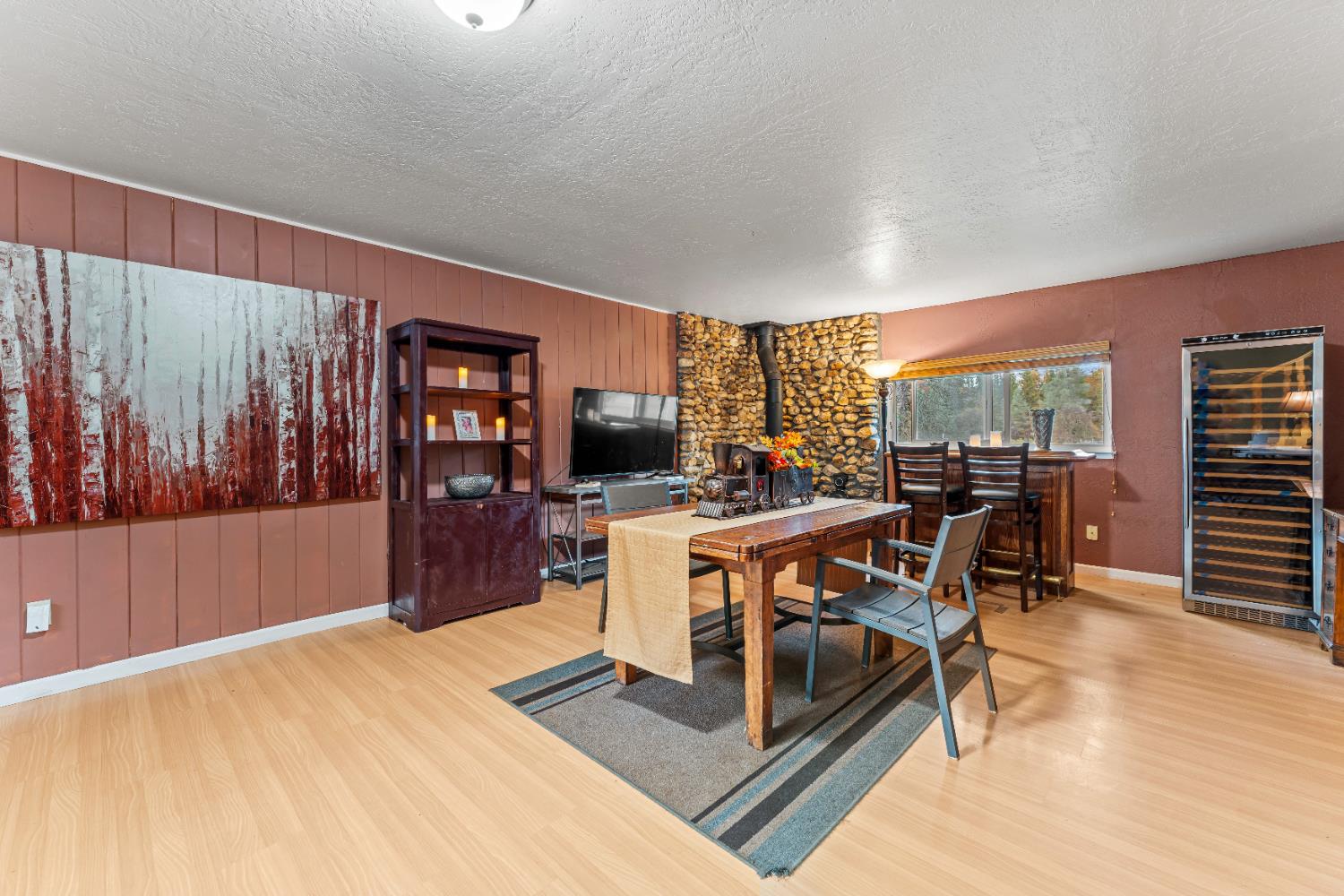 12987 Hidden Valley Road Grass Valley, CA 95949 - Photo 14 of 36 a living room with furniture a flat screen tv and a floor to ceiling window