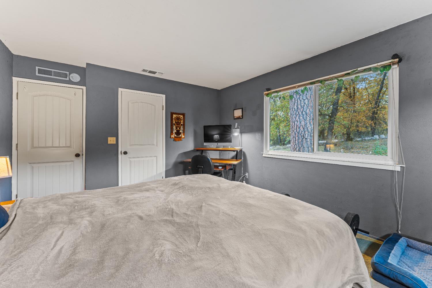 12987 Hidden Valley Road Grass Valley, CA 95949 - Photo 17 of 36 a bedroom with a large bed and a window