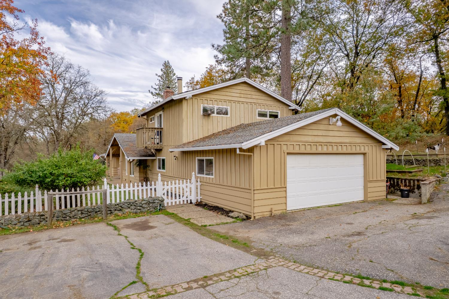 12987 Hidden Valley Road Grass Valley, CA 95949 - Photo 2 of 36 a view of a house with a yard and garage
