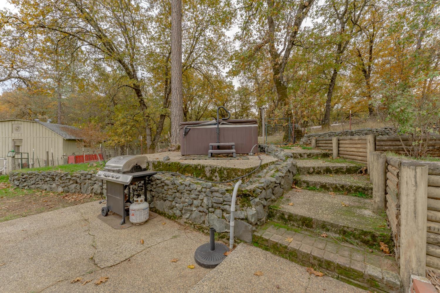12987 Hidden Valley Road Grass Valley, CA 95949 - Photo 26 of 36 a view of a chairs and table in the backyard