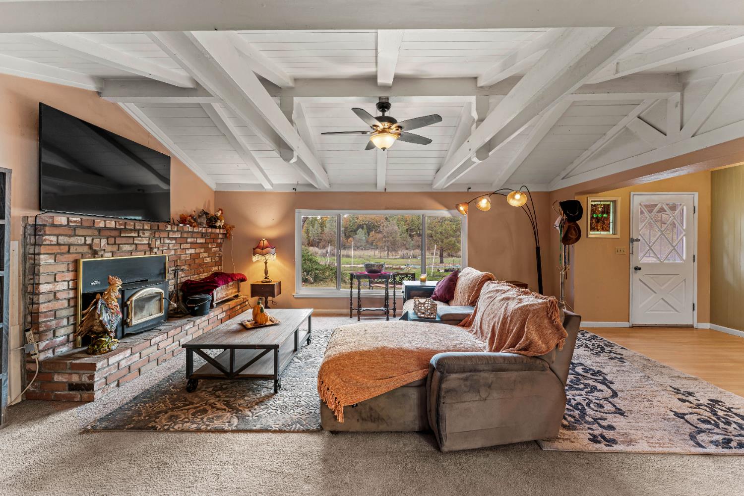 12987 Hidden Valley Road Grass Valley, CA 95949 - Photo 5 of 36 a living room with fireplace furniture and a flat screen tv