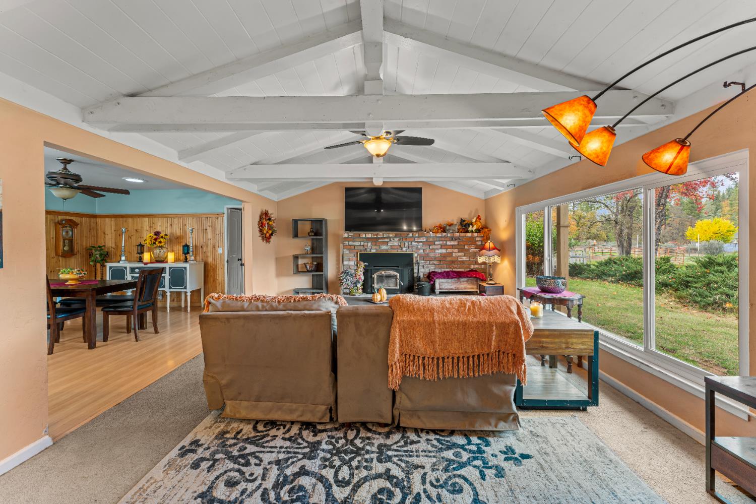 12987 Hidden Valley Road Grass Valley, CA 95949 - Photo 7 of 36 a living room with fireplace furniture and a floor to ceiling window