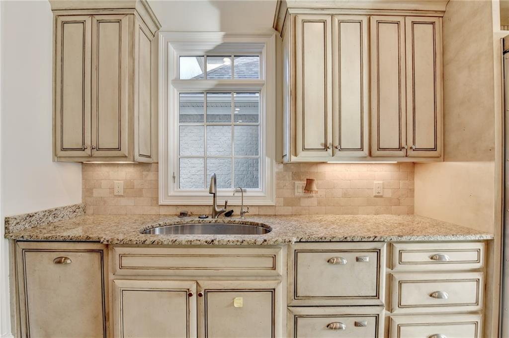 4045 Ridge Road Buford, GA 30519 - Photo 22 of 97 a kitchen with granite countertop stainless steel appliances white cabinets and a sink