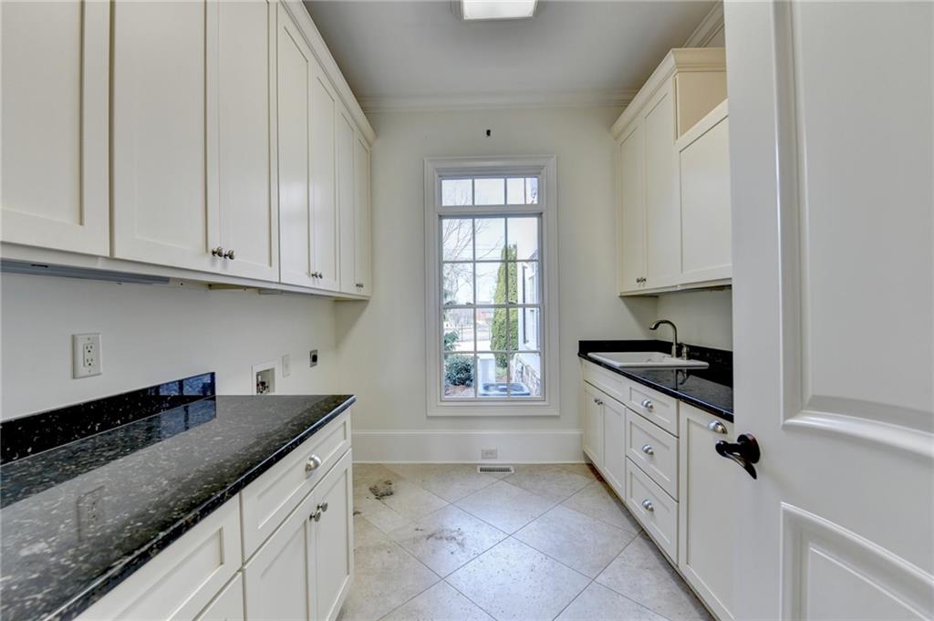 4045 Ridge Road Buford, GA 30519 - Photo 27 of 97 a kitchen with granite countertop white cabinets and sink