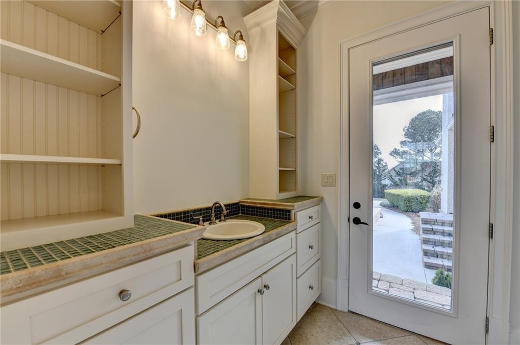 4045 Ridge Road Buford, GA 30519 - Photo 28 of 97 a bathroom with a granite countertop sink and a mirror