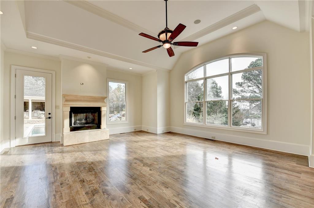 4045 Ridge Road Buford, GA 30519 - Photo 37 of 97 an empty room with wooden floor a ceiling fan and windows