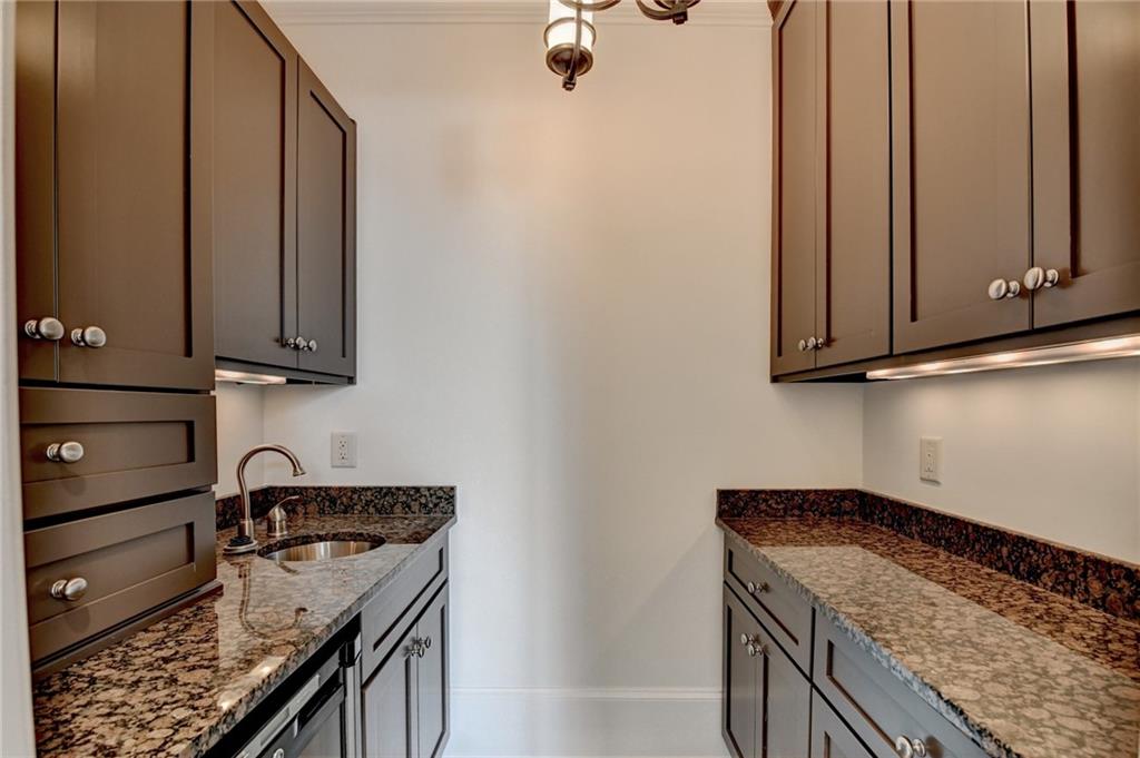4045 Ridge Road Buford, GA 30519 - Photo 42 of 97 a kitchen with stainless steel appliances granite countertop a sink stove and cabinets