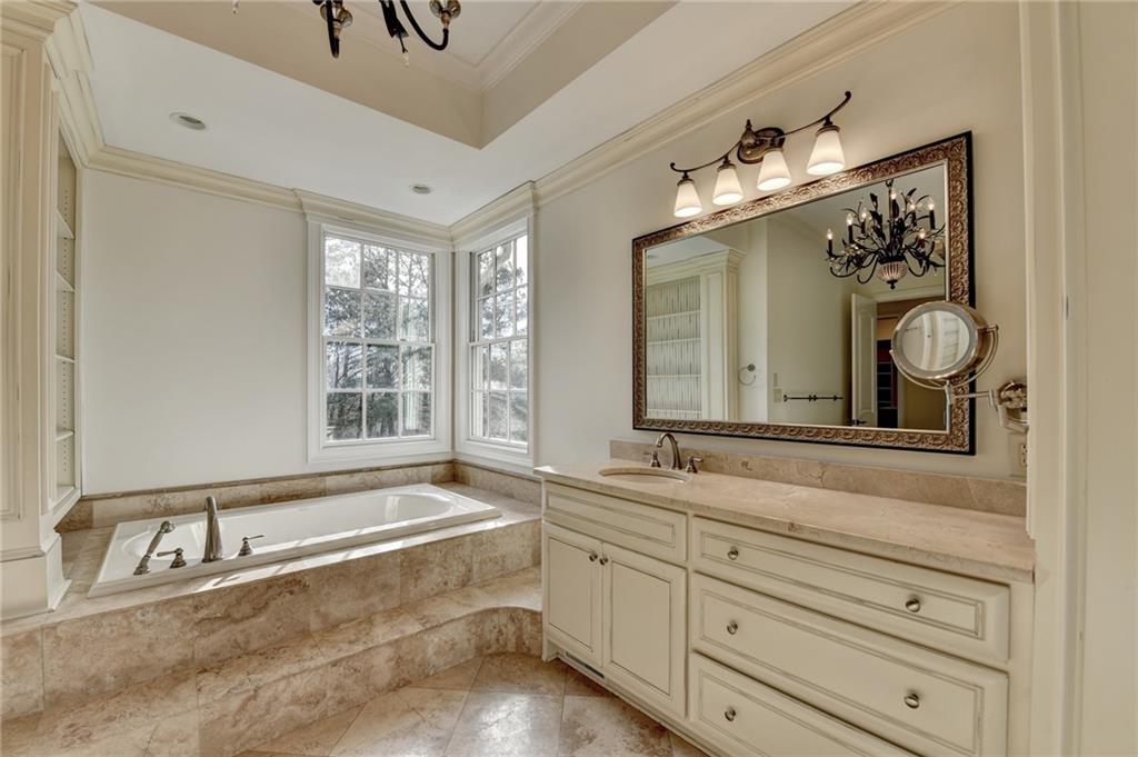 4045 Ridge Road Buford, GA 30519 - Photo 46 of 97 a bathroom with double vanity sink a bathtub and mirror