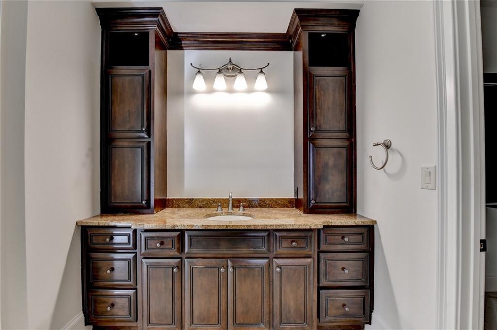 4045 Ridge Road Buford, GA 30519 - Photo 49 of 97 a bathroom with a granite countertop sink and a refrigerator