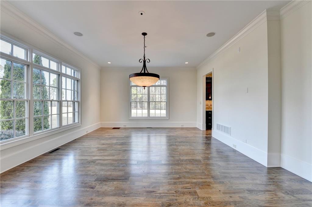 4045 Ridge Road Buford, GA 30519 - Photo 5 of 97 a view of an empty room with wooden floor and a window