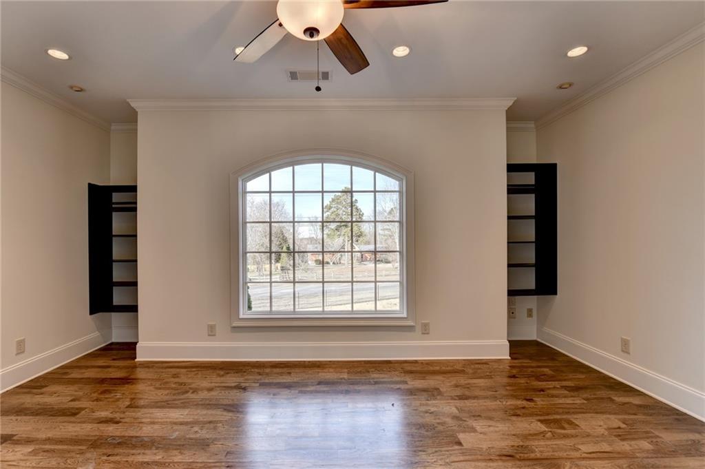 4045 Ridge Road Buford, GA 30519 - Photo 58 of 97 an empty room with wooden floor cabinet and windows