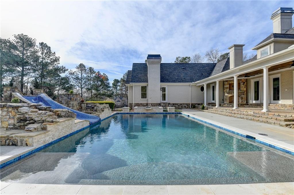 4045 Ridge Road Buford, GA 30519 - Photo 74 of 97 a swimming pool with outdoor seating and yard in the back