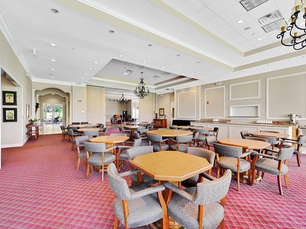 49 High Point Circle South, Unit 102 Naples, FL 34103 - Photo 1 of 31 a outdoor space with lots of furniture a rug and white walls