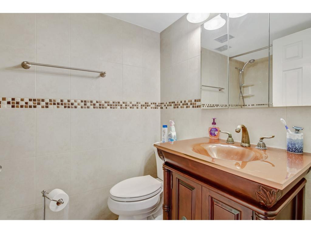 49 High Point Circle South, Unit 102 Naples, FL 34103 - Photo 21 of 31 a bathroom with a sink a toilet and shower