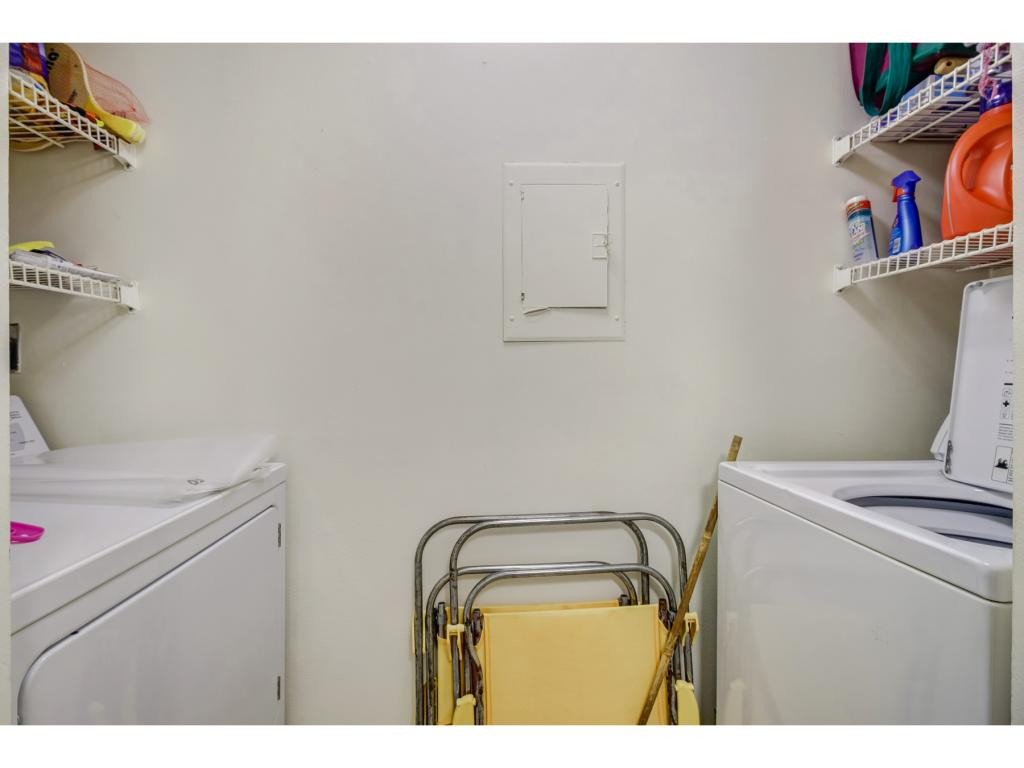 49 High Point Circle South, Unit 102 Naples, FL 34103 - Photo 22 of 31 a utility room with dryer and washer